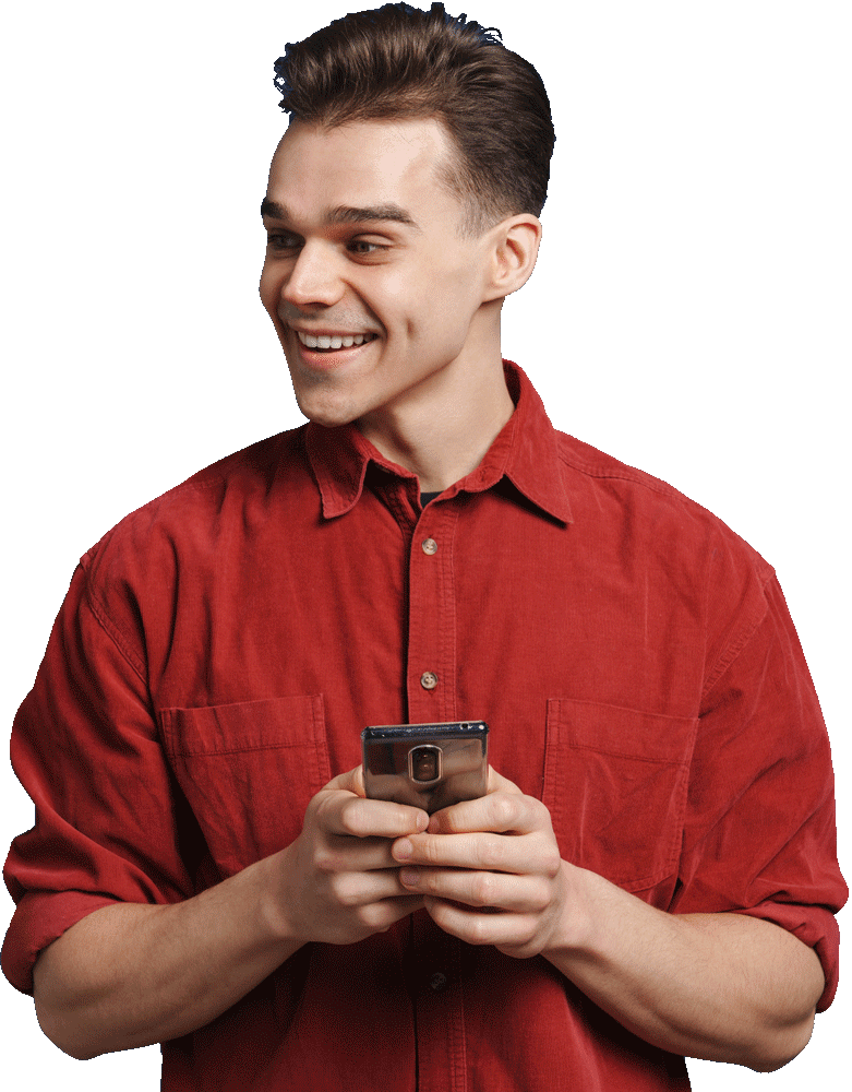A young man in a red shirt smiles while holding a smartphone with both hands, looking slightly to his right—ready to connect with his digital marketing agency.
